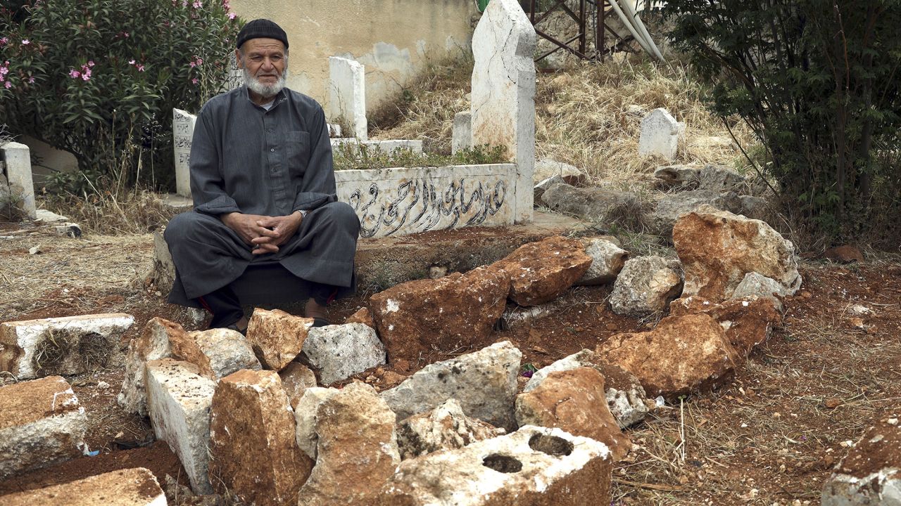 Mohammad Mesto sits next to the grave of his brother Lutfi, who was killed on May 3 in a suspected US military strike in northern Syria