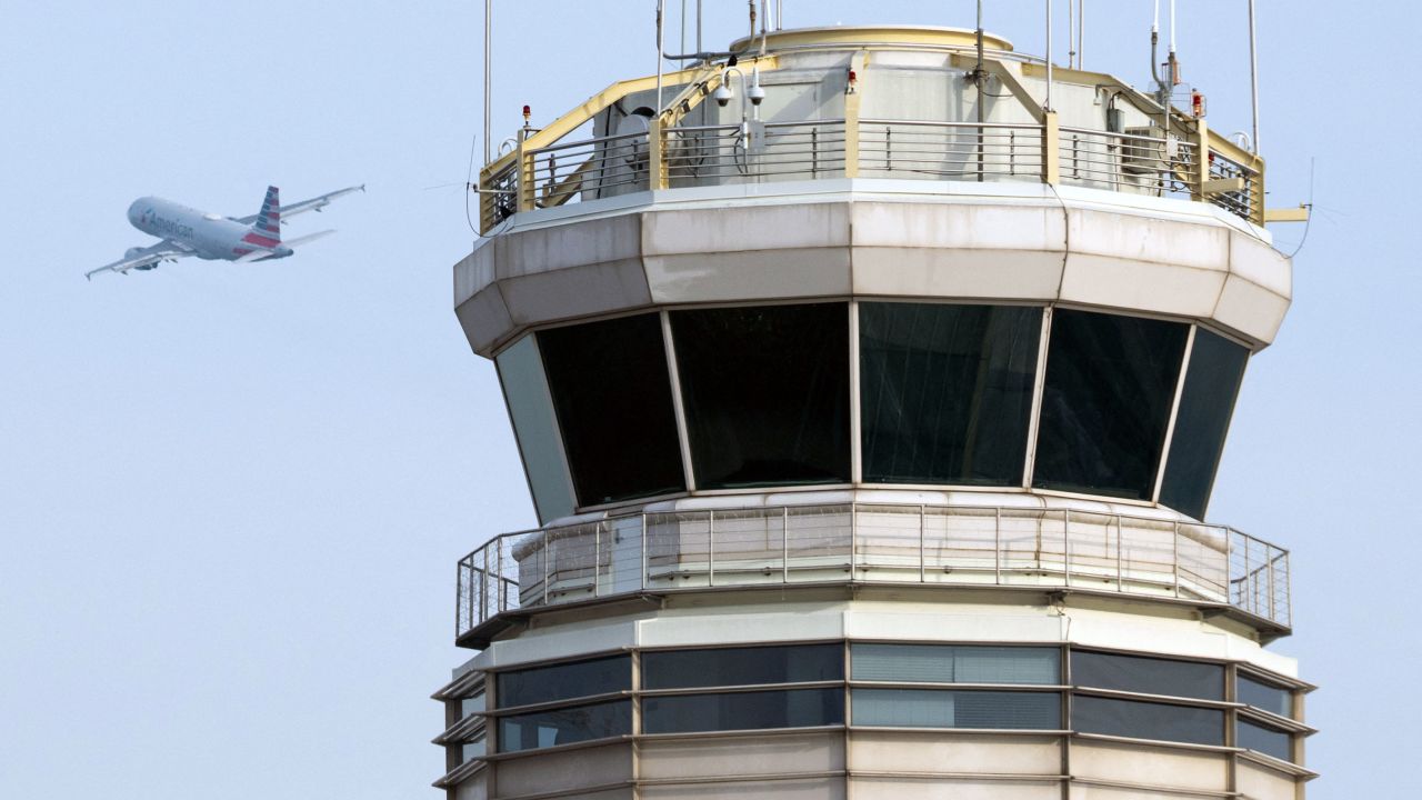 An American Airlines Airbus A319 airplane takes off past the air traffic control tower at Ronald Reagan Washington National Airport in Arlington, Virginia, in January.