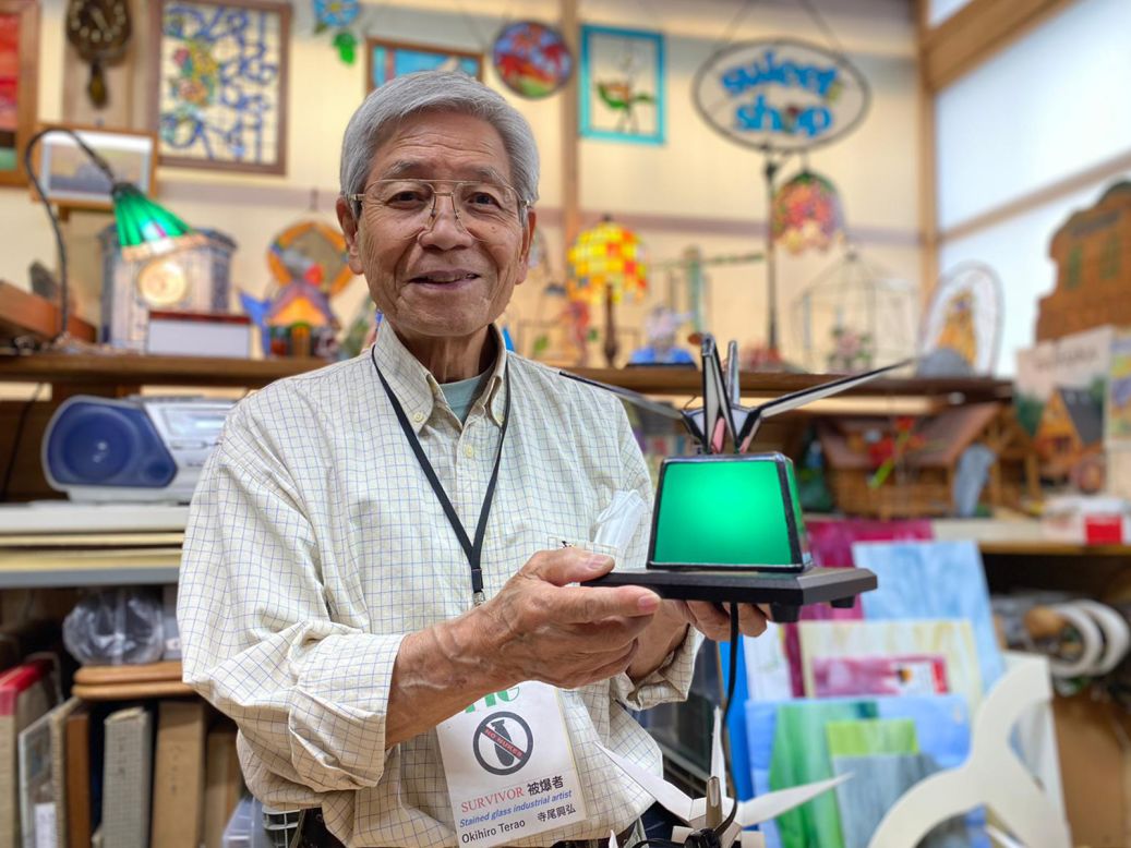 <strong>Hiroshima survivor: </strong>Okihiro Terao holds up a stained-glass crane that he made to symbolize peace. He said he sent one decorated in the colors of the Ukrainian flag to the Ukrainian Embassy in Tokyo.