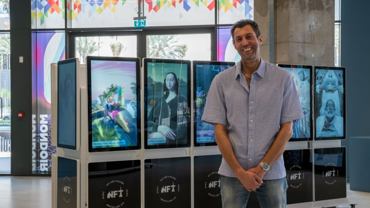 Amir "Mondoir" Soleymani, with NFT works on display at the Mondoir Art Gallery.