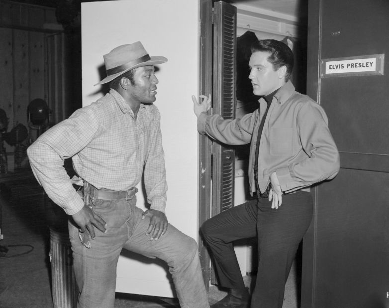 Brown visits with Elvis Presley as Presley was filming the 1964 film "Roundabout." Brown was working on the Western movie "Rio Conchos," which was his film acting debut.