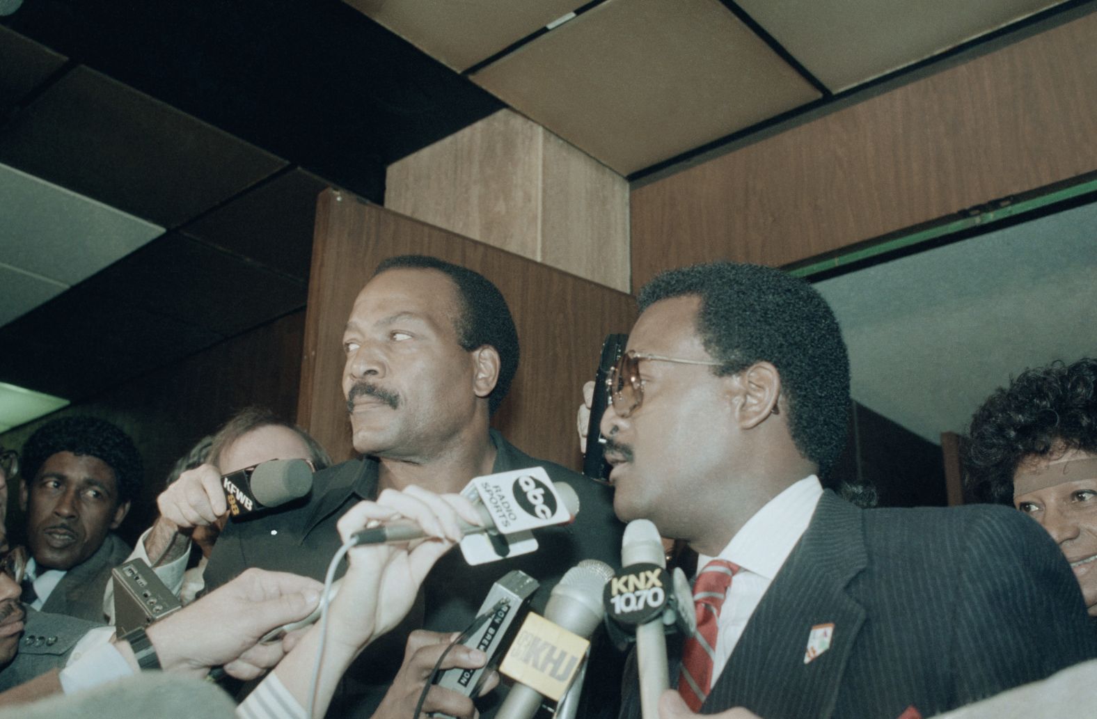 Brown and attorney Johnnie Cochran enter a court in Los Angeles in 1985. That year, Brown was charged with raping and assaulting a 33-year-old woman in his home. The judge later dismissed the charges based on inconsistent testimony. During the 1960s, Brown was charged on two separate occasions with assaulting women: a jury found him not guilty in one case, and the charge was dismissed in the other after the woman refused to name him as her assailant. In 1999, following a domestic disturbance with his wife, Monique, Brown was arrested and charged with making terrorist threats toward her. In the 911 tape, she accused Brown of threatening to kill her, a claim she later recanted. A jury found Brown guilty of vandalism for smashing his wife's car with a shovel.