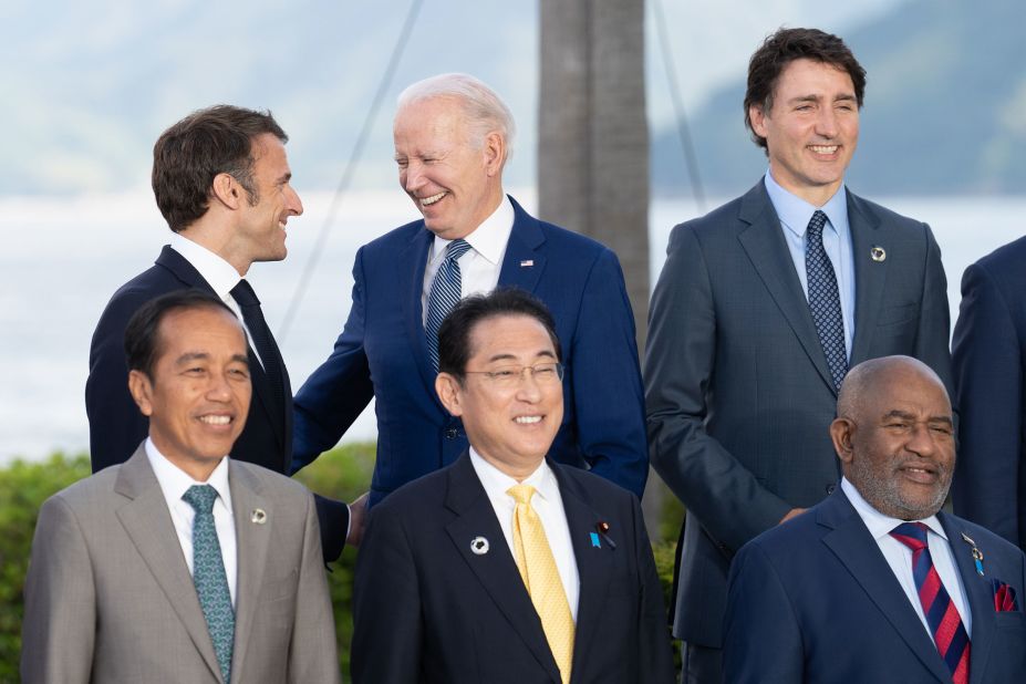 French President Emmanuel Macron and US President Joe Biden share a laugh while taking a group picture at the Grand Prince Hotel in Hiroshima during the G7 Summit on Saturday, May 20, in Japan.