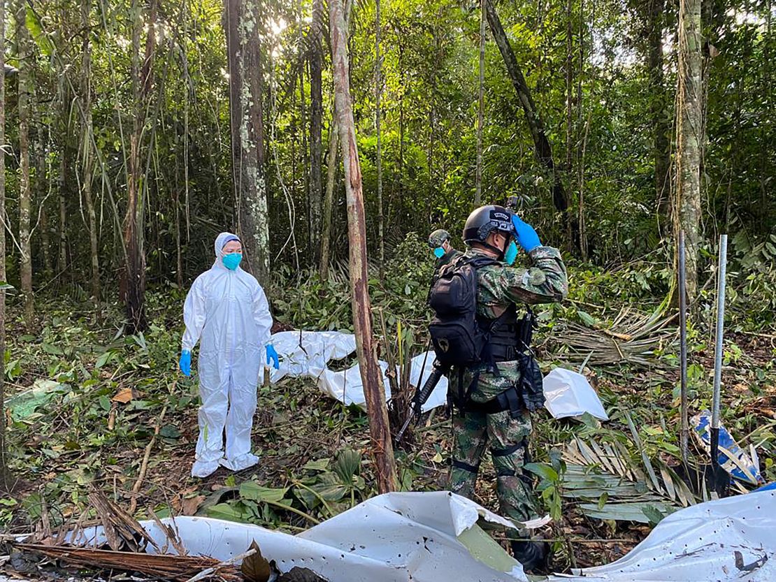 Soldiers stand next to the wreckage of a plane during the search for child survivors on May 19, 2023.