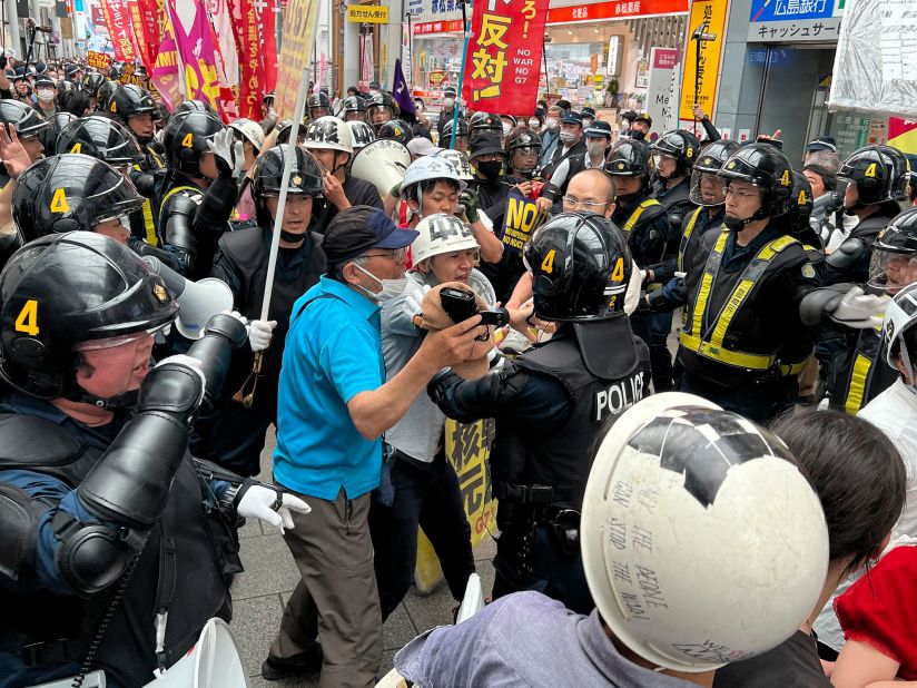 Protesters confront riot police during a march against the G7 meeting on Sunday in Hiroshima.