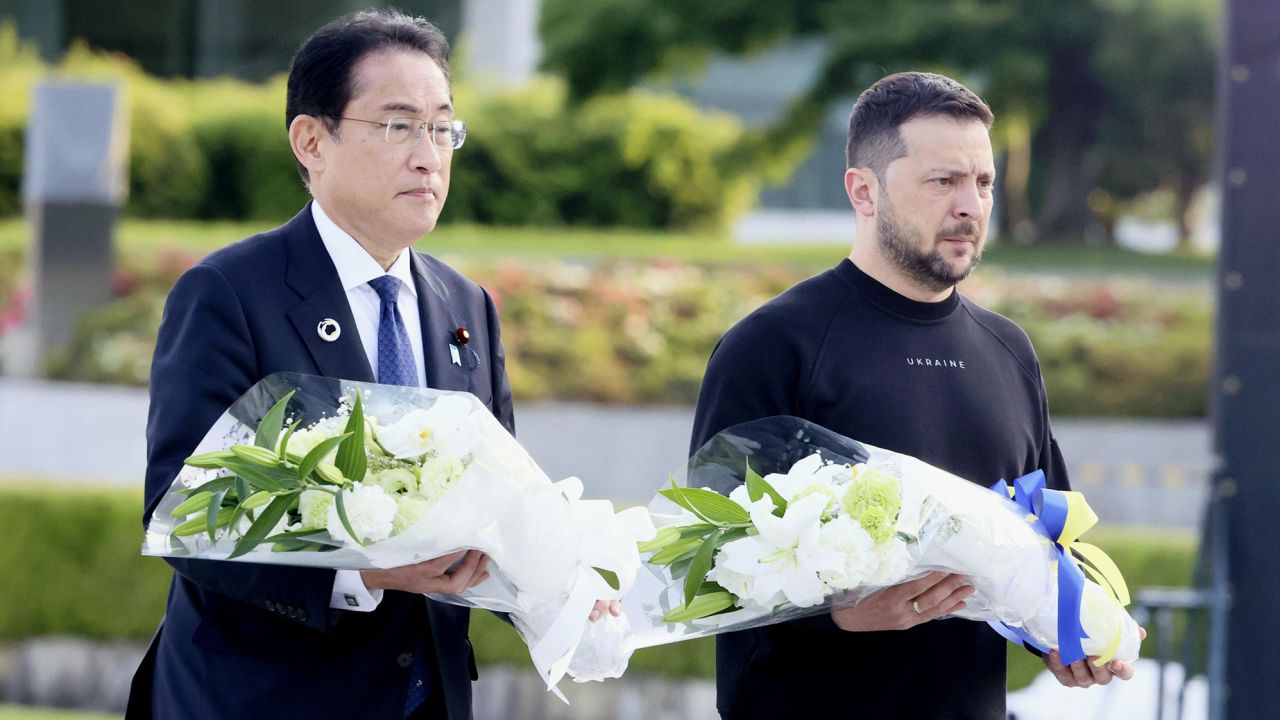 Japanese Prime Minister Fumio Kishida and Ukrainian President Volodymyr Zelensky walk toward the cenotaph for atomic bomb victims at the Peace Memorial Park in Hiroshima on May 21, 2023.