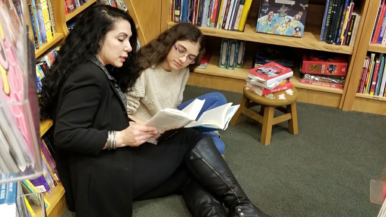 Susan Muaddi Darraj, author of "Farah Rocks," reads with her daughter, Mariam, who inspired the series.