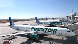 Frontier Airlines planes are parked at gates at Denver International Airport September 25, 2021, in Denver.