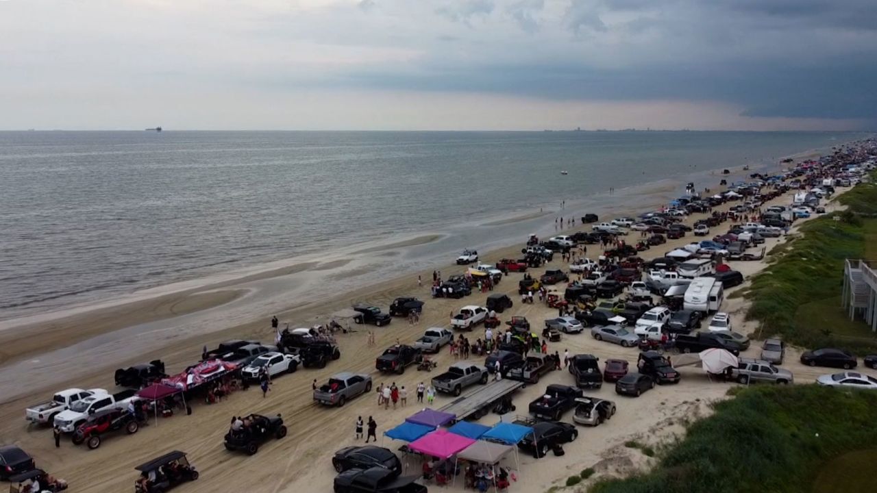 A beach in Crystal Beach, Texas, is filled with people attending the "Jeep weekend event."
