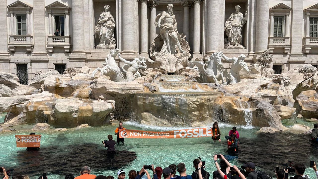 Climate activists from the group Last Generation stand inside the Trevi Fountain in Rome.