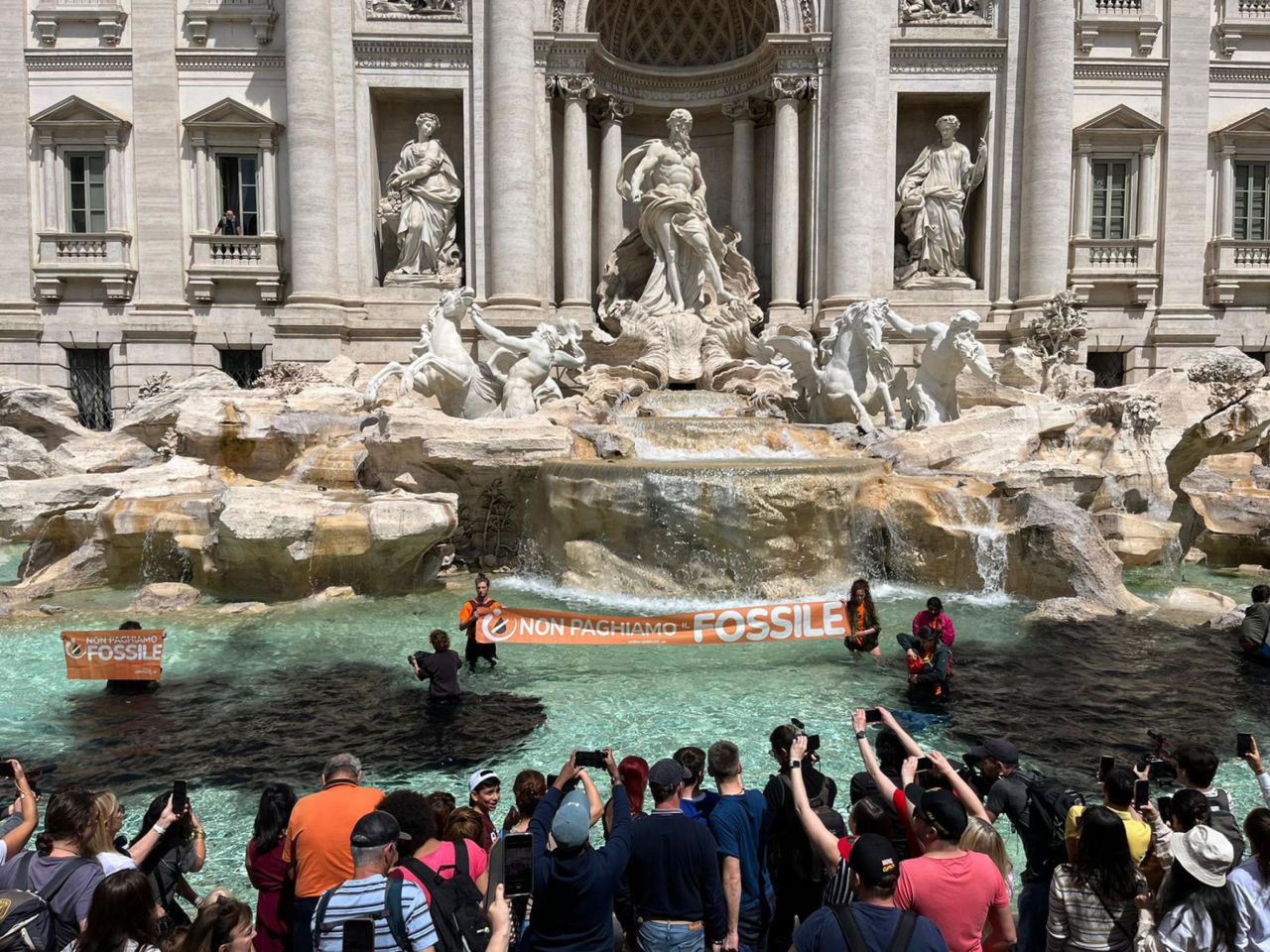 Climate activists from the group Last Generation stand inside the Trevi Fountain in Rome.
