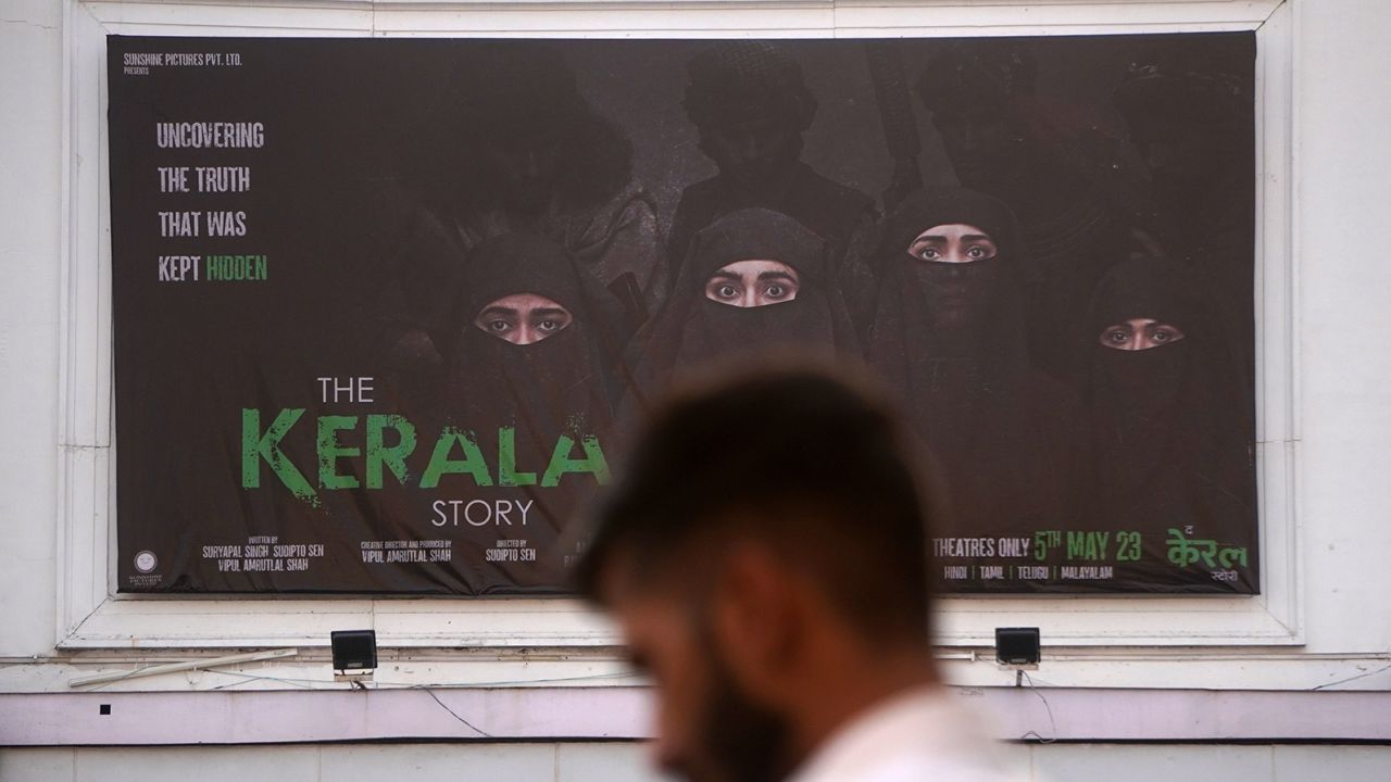 A man walks past a poster of the movie The Kerala Story, outside a movie theatre in New Delhi, India on May 13, 2023. 