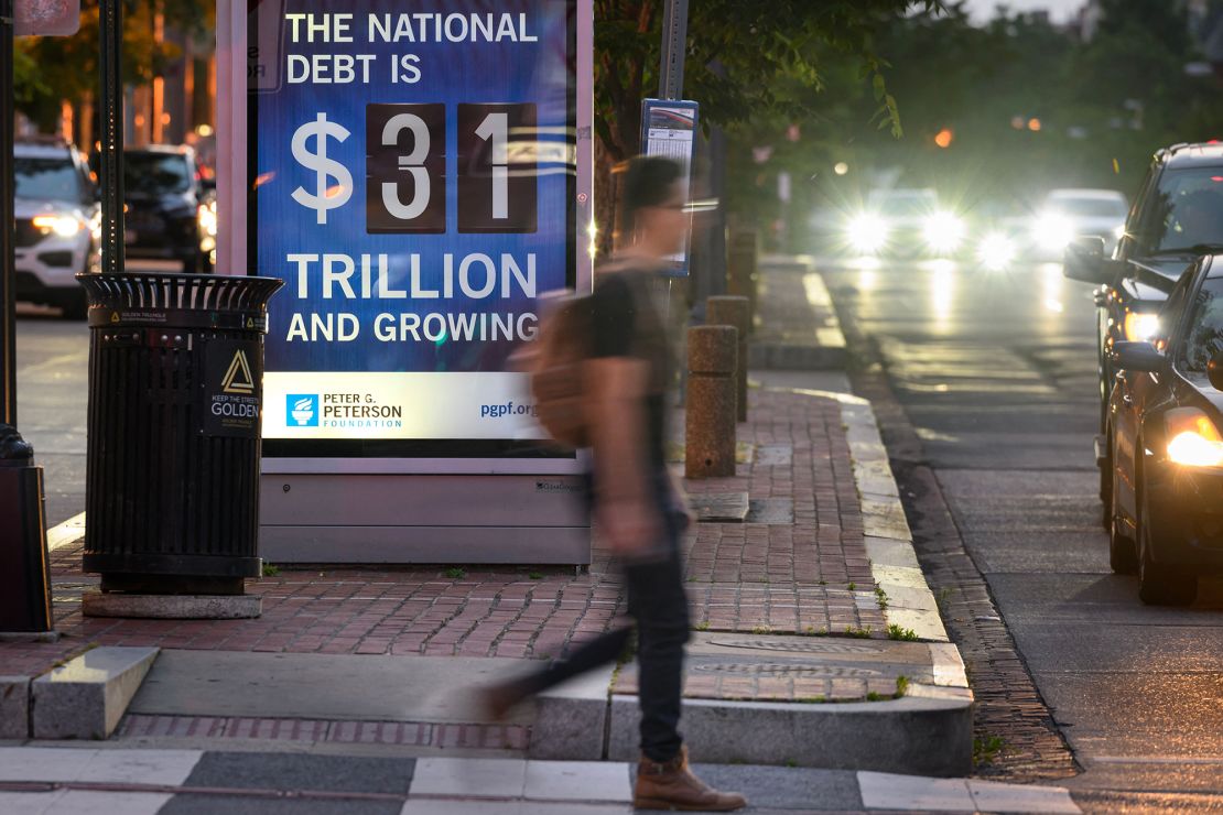 A poster at a bus shelter shows the national debt in Washington, DC, on May 21, 2023.