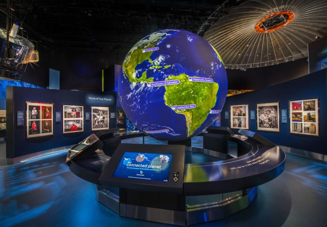 The world's largest collection of historic aircraft and spacecraft can be found at the Smithsonian National Air and Space Museum in Washington D.C. In this image, an interactive 10-foot spherical projection of a globe is suspended in the middle of the "One World Connected" gallery, where visitors can pull up data visualizations ranging from satellite networks to animal migration routes. 