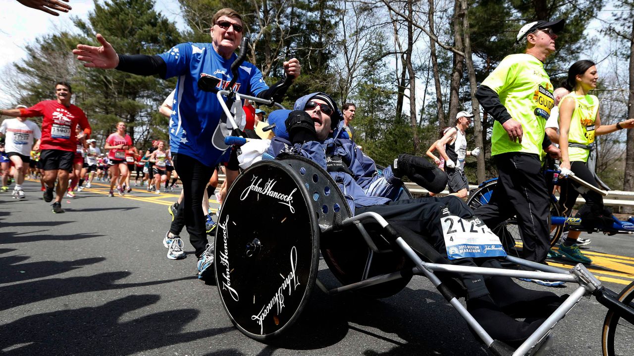 Rick Hoyt, center, is pushed by his late father, Dick, along the Boston Marathon course during the 2013 race.