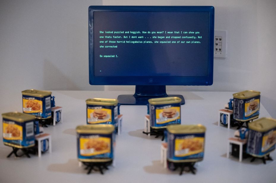 At the Misalignment Museum, an army of robotic Spam cans type out prose generated by an AI large language model. Created by Neil Mendoza, the cans are retrofitted with arms so they can type out the entire alphabet.