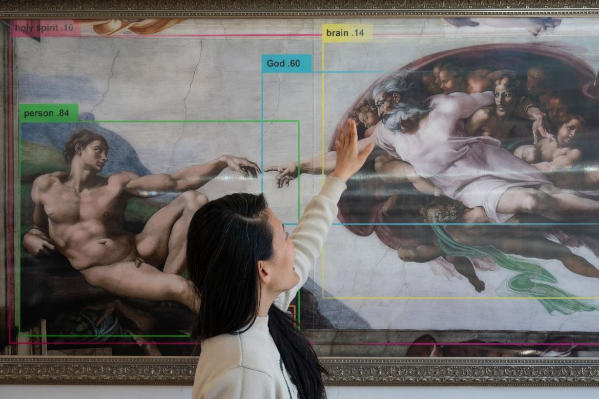 Through its tongue-in-cheek exhibits, the Misalignment Museum is on a mission to increase knowledge about artificial intelligence and its potential for both destruction and good. Its pop-up pilot in San Francisco ended in May and it is now planning its next public exhibit. Pictured, curator and artist Audrey Kim with the piece "Genesis: In The Beginning Was The Word," by Eurypheus
