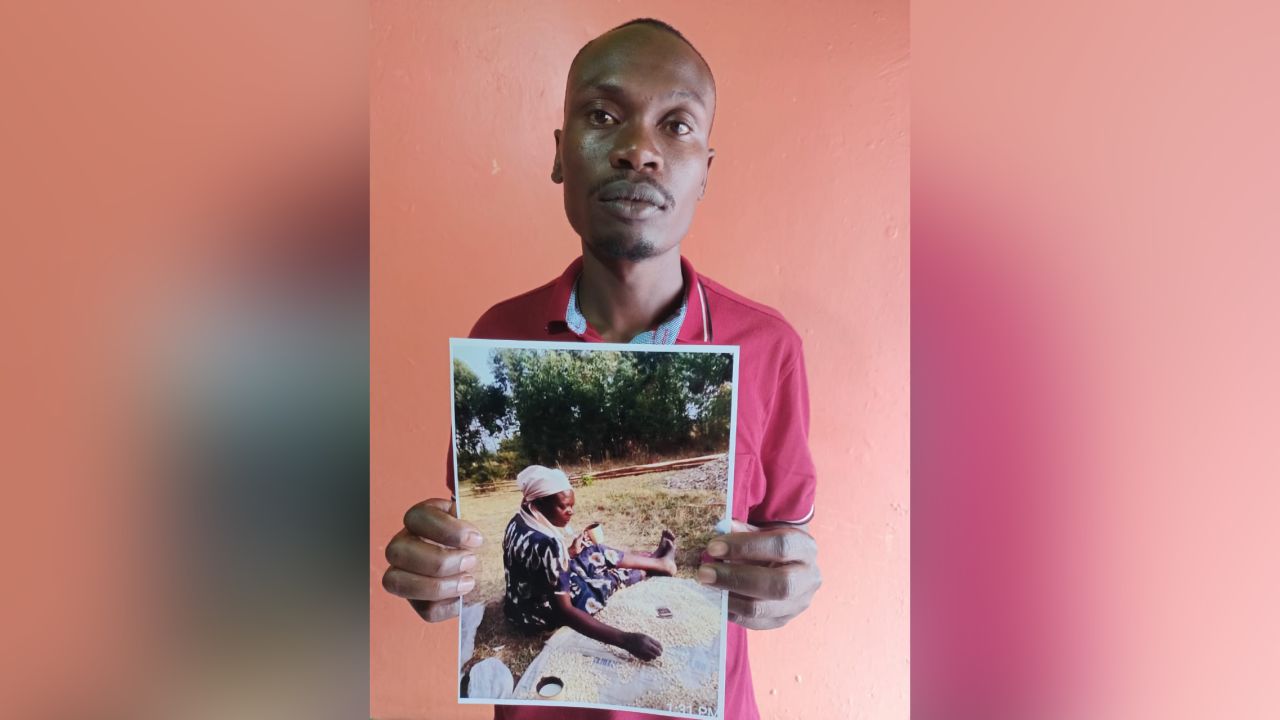 Rodgers Shibutse holds a picture of his missing mother Pamela Mukalasinga.