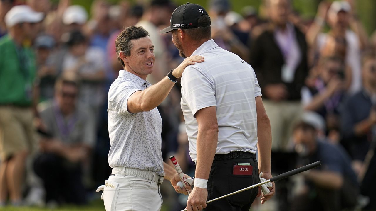 Block and McIlroy embrace after their final rounds at the 2023 PGA Championship.