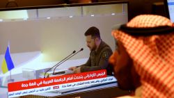 Media delegates watch Ukraine's President Volodymyr Zelensky addressing the Arab League Summit in Jeddah on May 19, 2023. Zelensky accused some Arab leaders of ignoring the horrors of Russia's invasion of his country during a speech today at an Arab League summit in Saudi Arabia. (Photo by Fayez Nureldine / AFP) (Photo by FAYEZ NURELDINE/AFP via Getty Images)