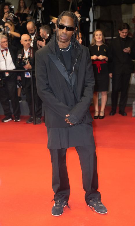 At the same screening, Travis Scott arrived in sunglasses, a black blazer layered over a pair of back shorts and a hoodie.