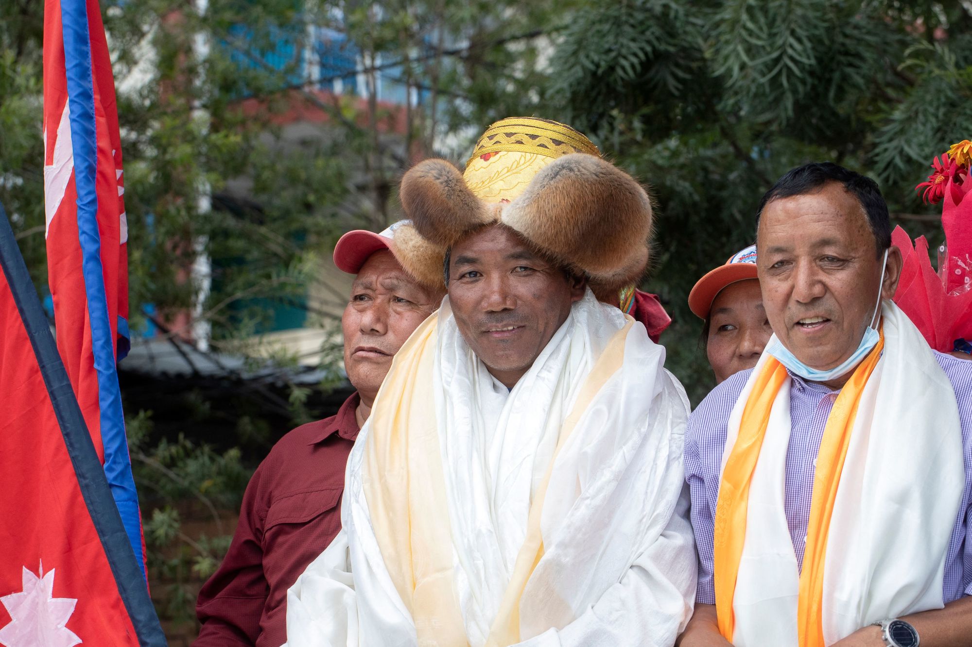 Nepali mountaineer Kami Rita Sherpa (C), who broke his own world record for the most summits after climbing Mount Everest for the 26th time, is welcomed after arriving at Tribhuvan airport in Kathmandu on May 27, 2022. (Photo by BIKASH KARKI / AFP) (Photo by BIKASH KARKI/AFP via Getty Images)