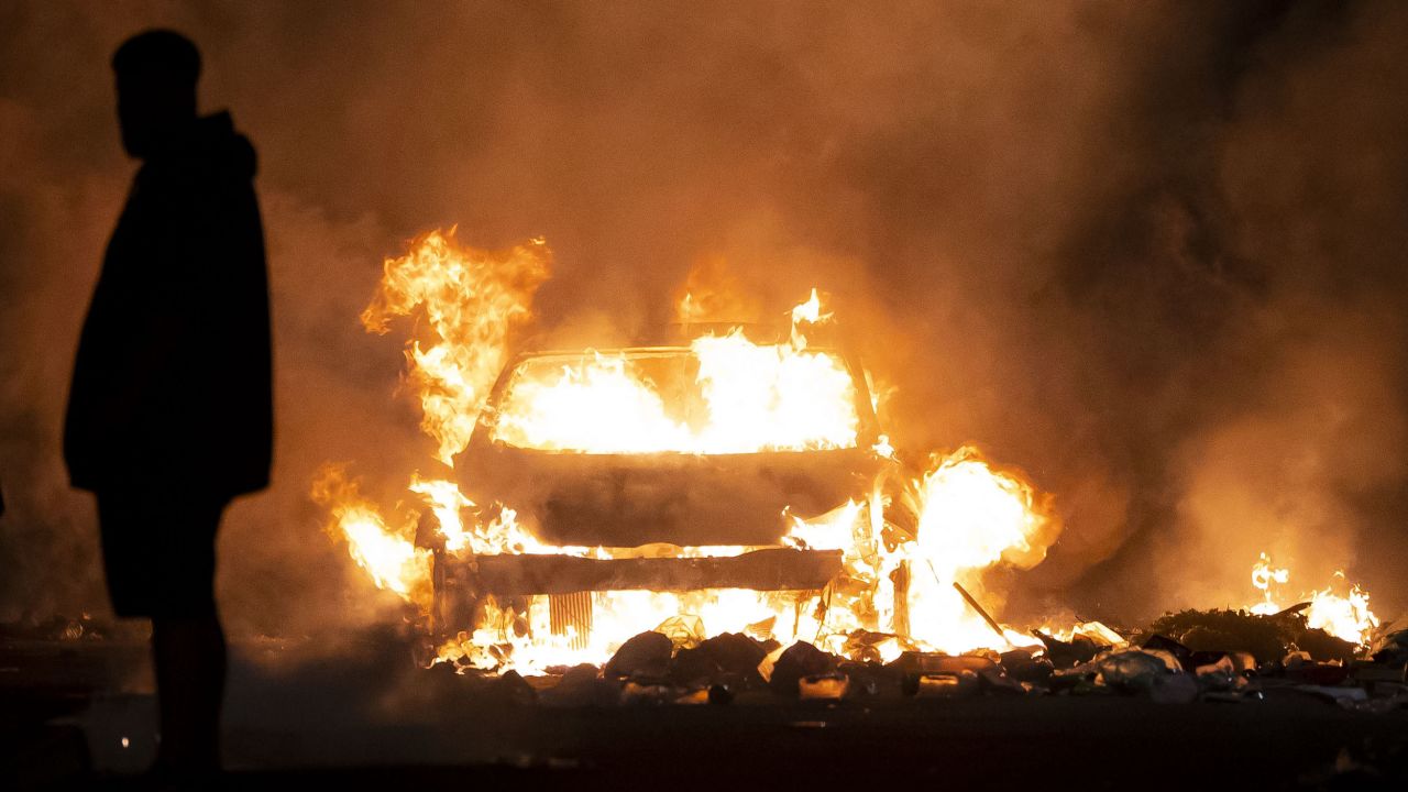 A car burns during riots in Cardiff on Monday. 