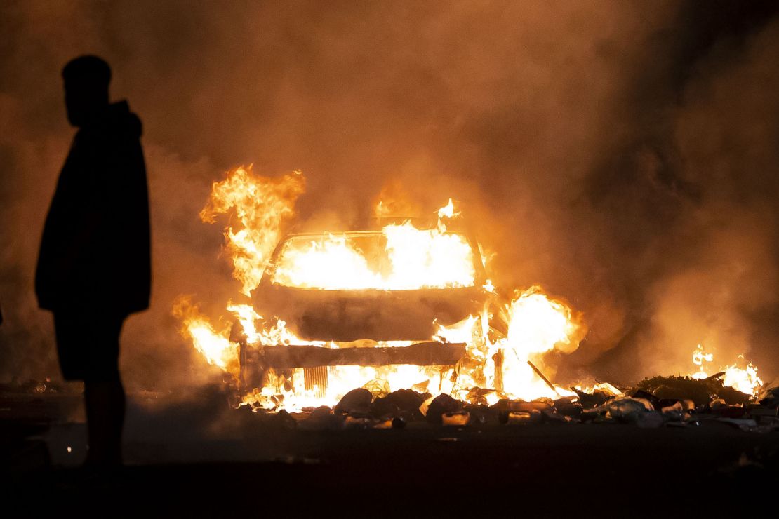 A car burns during riots in Cardiff on Monday.