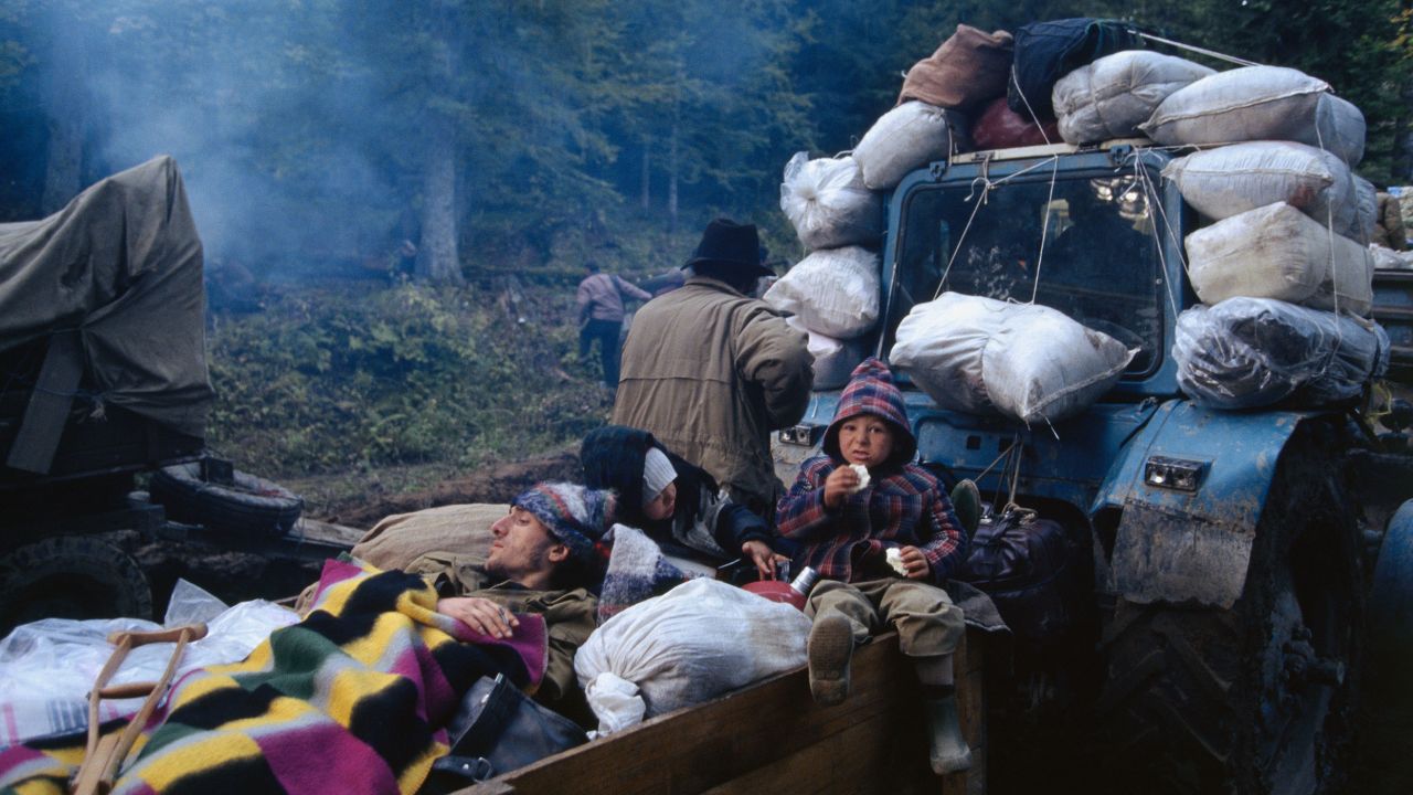 Refugees ride a tractor during the exodus of people after Russia invaded Abkhazia in the early 1990s. Dzvelaia's family fled at the same time.