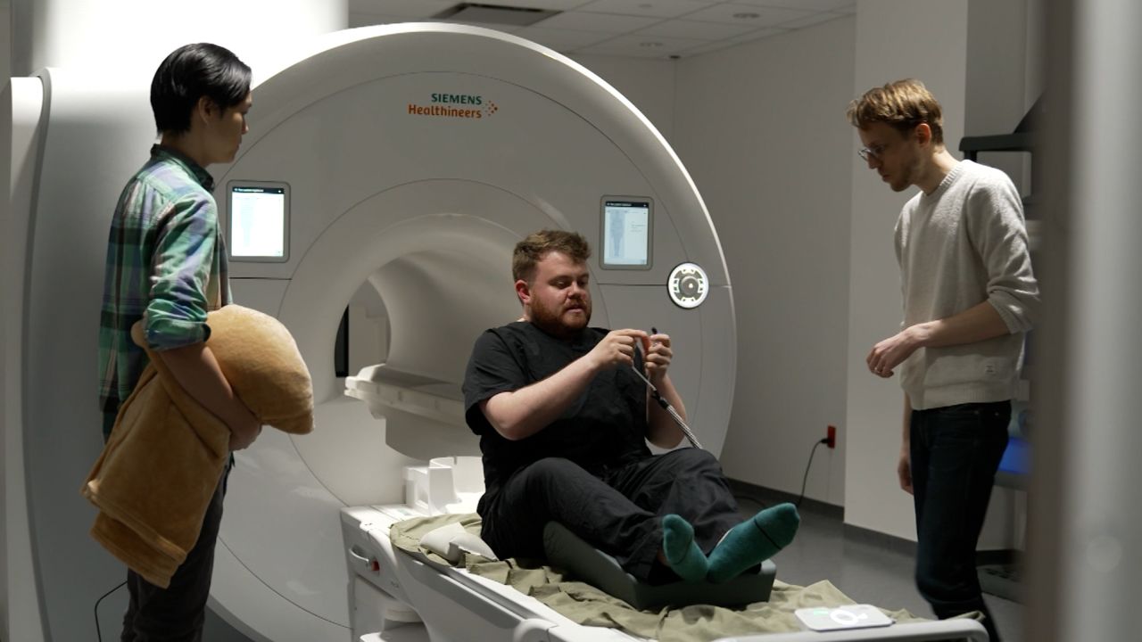 Before entering the fMRI machine, CNN correspondent Donie O'Sullivan was given specialized earphones to listen to an audiobook during his brain scan.