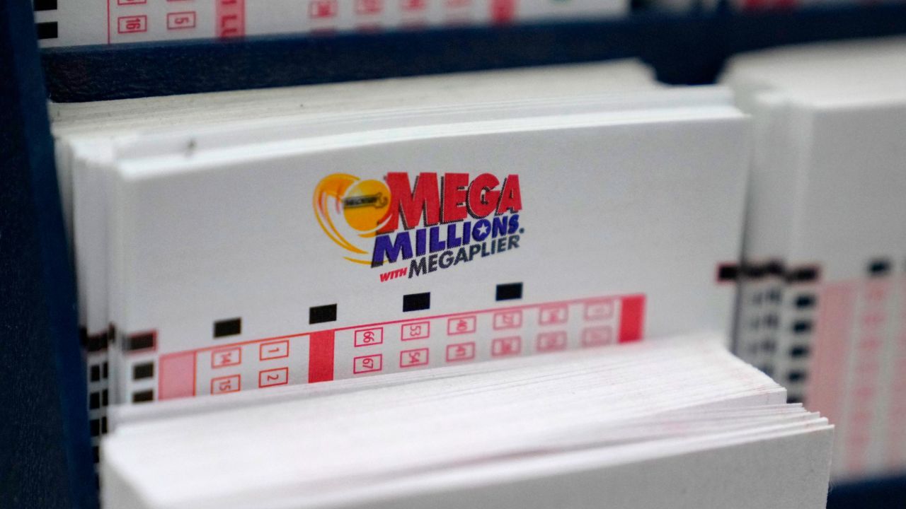 A display holds Mega Million lottery ticket wagering cards at Ted's State Line Mobil station on January 5, 2023, in Methuen, Massachusetts.