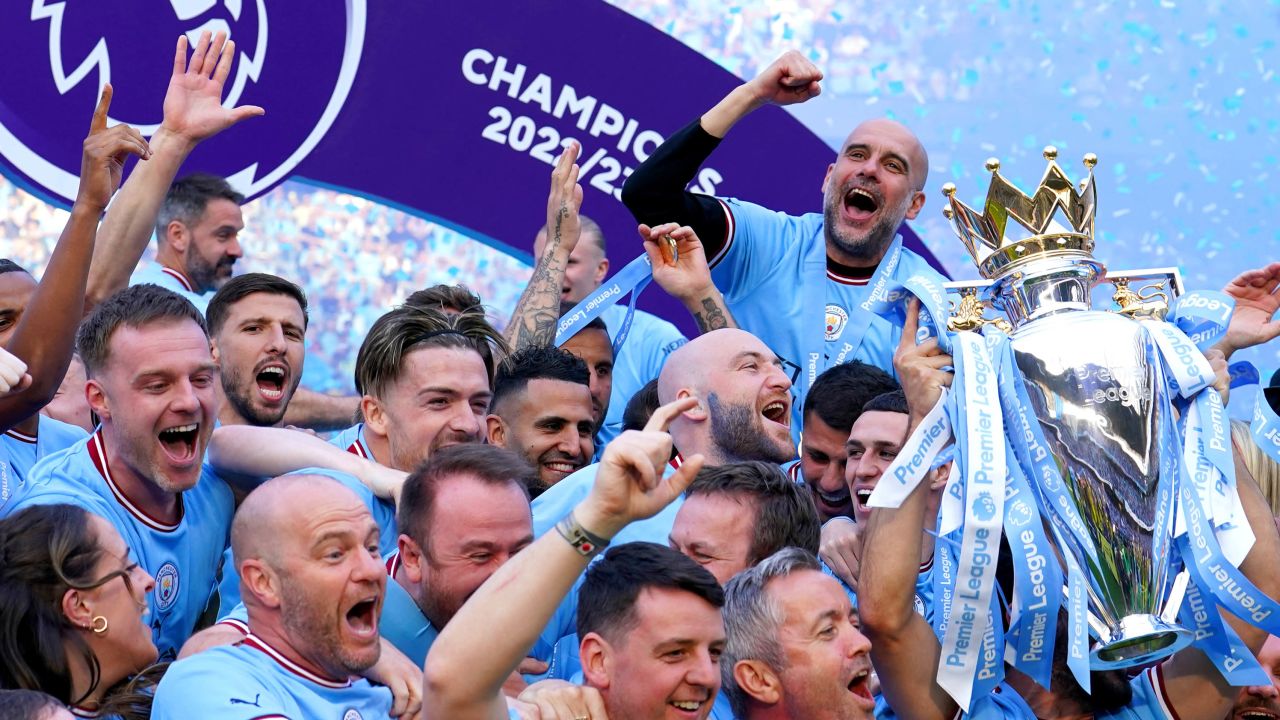 Guardiola celebrates winning the Premier League title with Man City's players and staff.