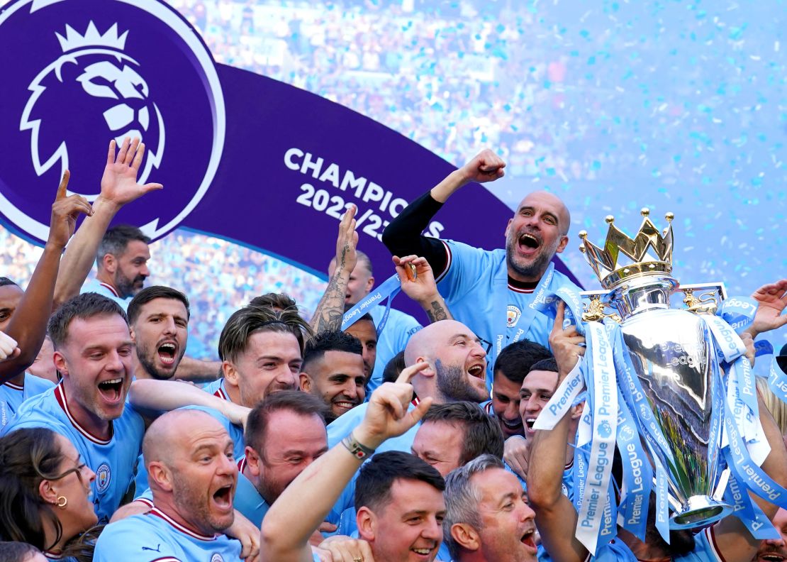 Guardiola celebrates winning the Premier League title with Man City's players and staff.