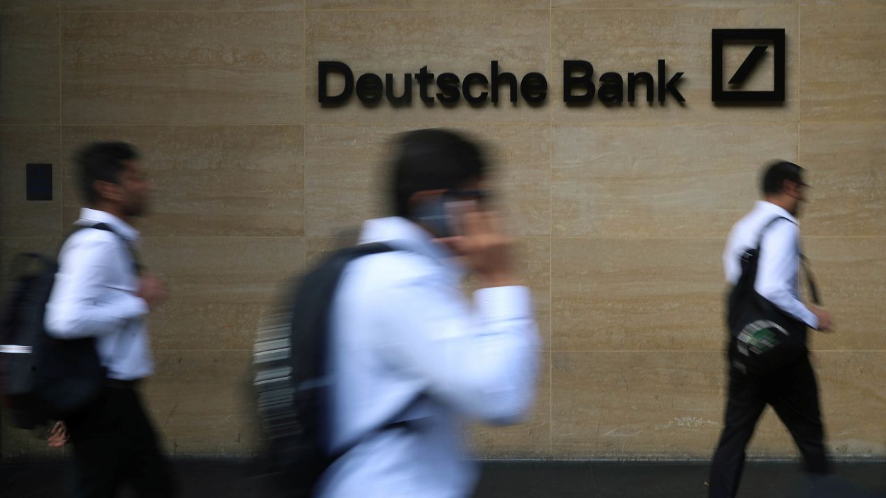 People walk past a Deutsche Bank office in London in 2019. 