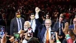 India's Prime Minister Narendra Modi (L) and Australia's Prime Minister Anthony Albanese gesture as they leave from an event with members of the local Indian community at the Qudos Arena in Sydney on May 23, 2023. 