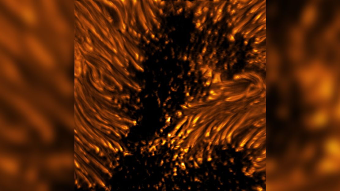 This image reveals the fine structures of a sunspot in the photosphere. Within the dark, central area of the sunspot's umbra, small-scale bright dots, known as umbral dots, are seen. The elongated structures surrounding the umbra are visible as bright-headed strands known as penumbral filaments. Umbra: Dark, central region of a sunspot where the magnetic field is strongest. Penumbra: The brighter, surrounding region of a sunspot's umbra characterized by bright filamentary structures.