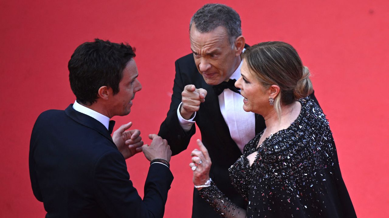 (From left) A Cannes Film Festival staff member, Tom Hanks and Rita Wilson at the premiere of 'Asteroid City' on Tuesday in France.