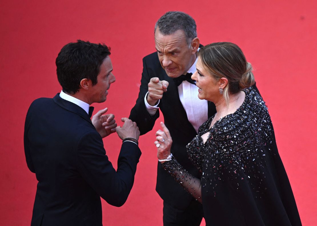 (From left) A Cannes Film Festival staff member, Tom Hanks and Rita Wilson at the premiere of 'Asteroid City' on Tuesday in France. 