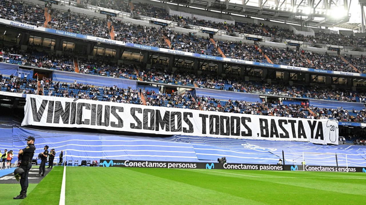 A picture taken prior the Spanish league football match between Real Madrid CF and Rayo Vallecano de Madrid shows a banner reading 'We all are Vinicius. Enough (of racism)' referring to Real Madrid's Brazilian forward Vinicius Junior at the Santiago Bernabeu stadium in Madrid on May 24, 2023. Vinicius drew global support after making a stand against racist abuse he received on May 21 from Valencia supporters at their Mestalla stadium. (Photo by JAVIER SORIANO / AFP) (Photo by JAVIER SORIANO/AFP via Getty Images)