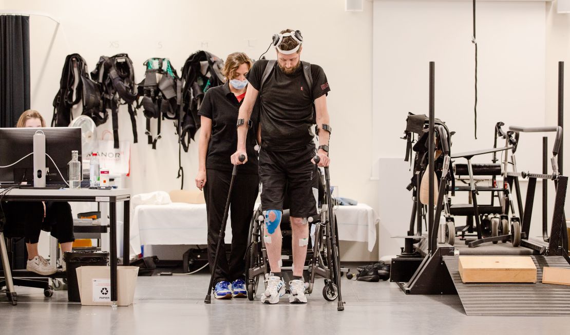 Patient and scientist walking with digital bridge at Lausanne University Hospital, EPFL, Credit: Jimmy Ravier