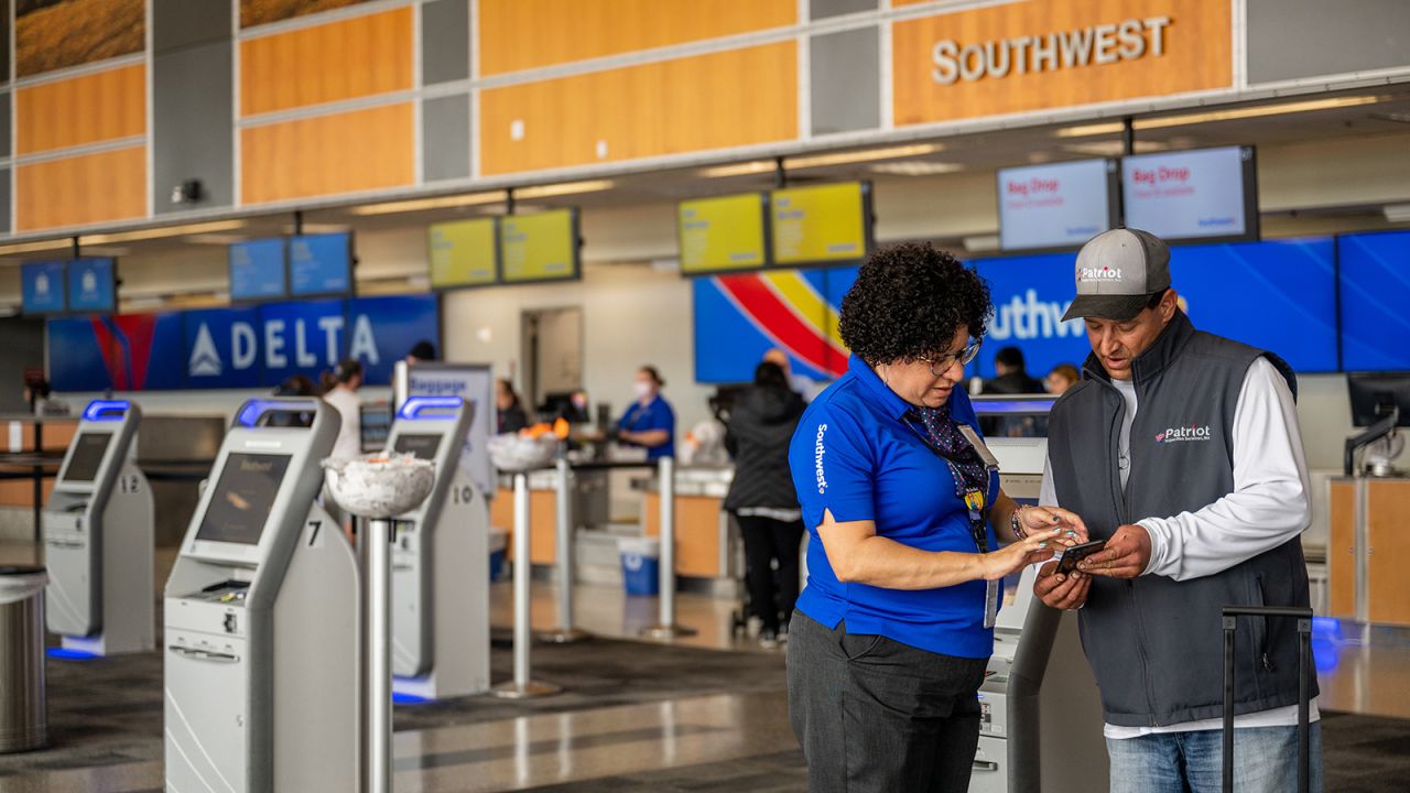 AUSTIN, TEXAS - APRIL 18: A Southwest Airlines employee assists a passenger during their check-in at the Austin-Bergstrom International Airport on April 18, 2023 in Austin, Texas. Southwest Airlines suffered a brief disruption in operations earlier this morning after a computer firewall issue forced the company to delay many of its flights. (Photo by Brandon Bell/Getty Images)