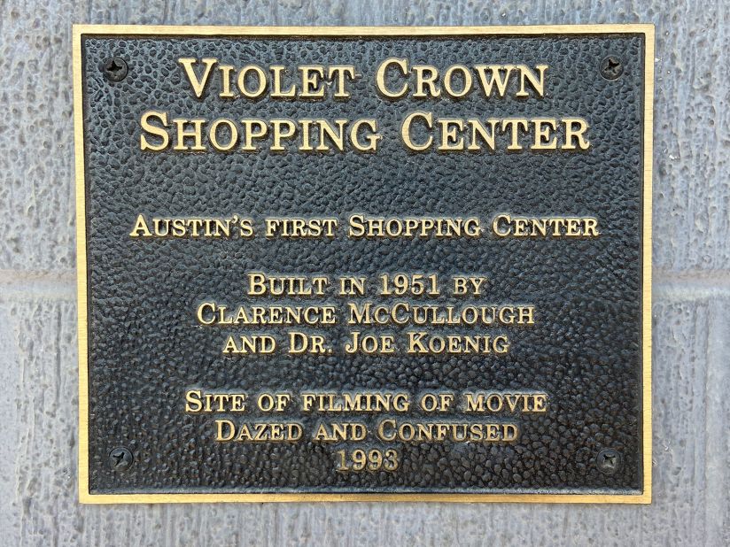 A plaque on the Violet Crown Shopping Center certifies it as the location cinematically known as the Emporium in "Dazed and Confused."