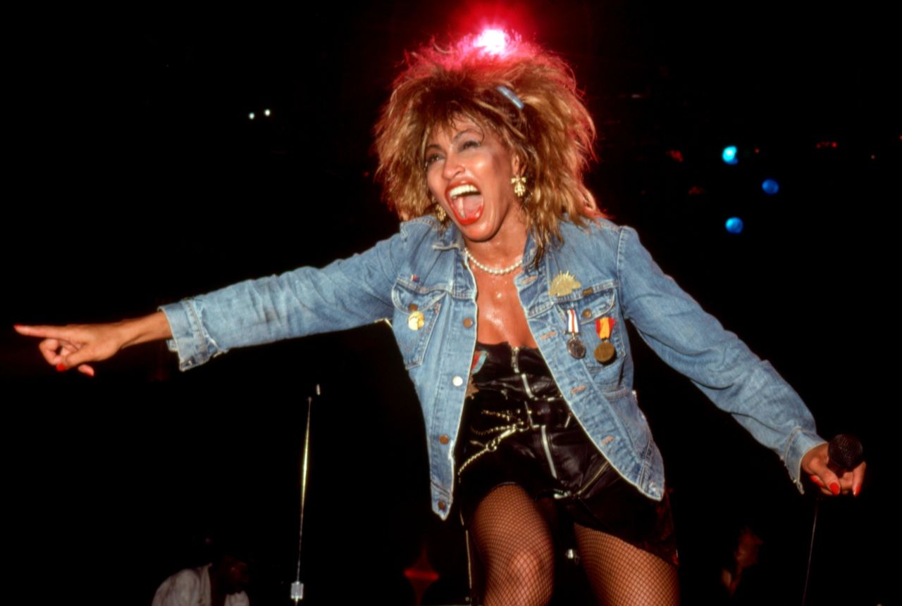 A denim jacket and black leather mini dress became Turner's signature look during her "Private Dancer" era.