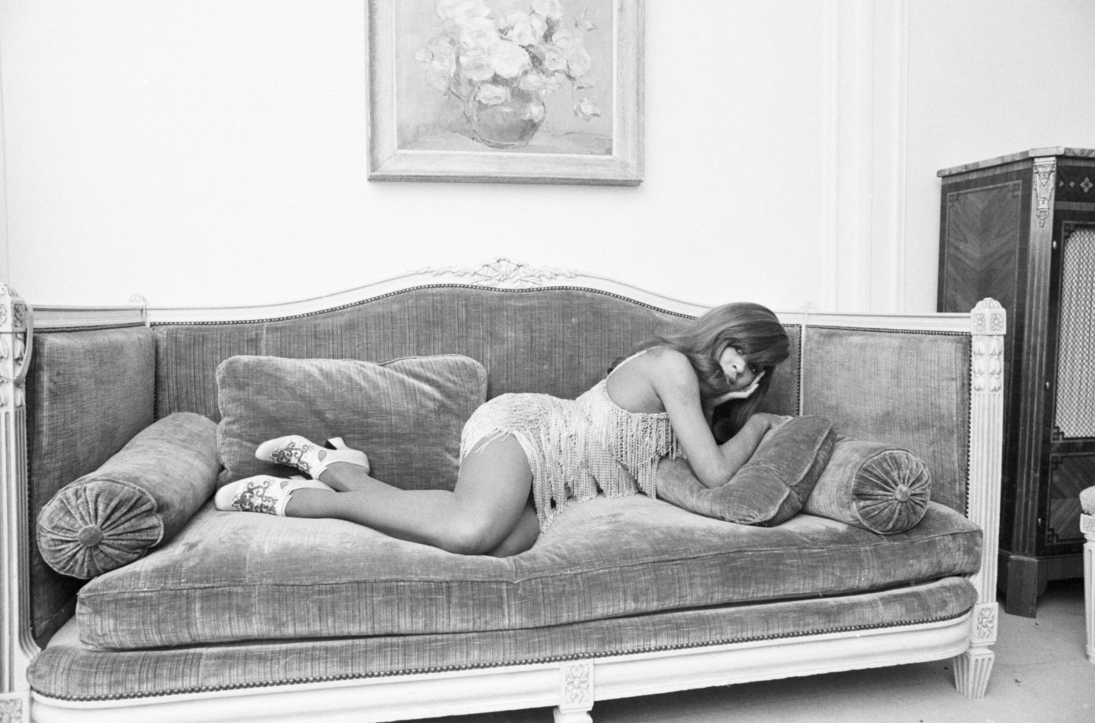 Turner poses on a velvet sofa in Paris in 1971.