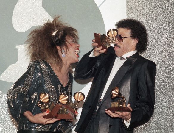 Turner shares a laugh with Lionel Richie as they celebrate their Grammy Award wins in 1985. She won three Grammys that year, including record of the year for "What's Love Got to Do With It."