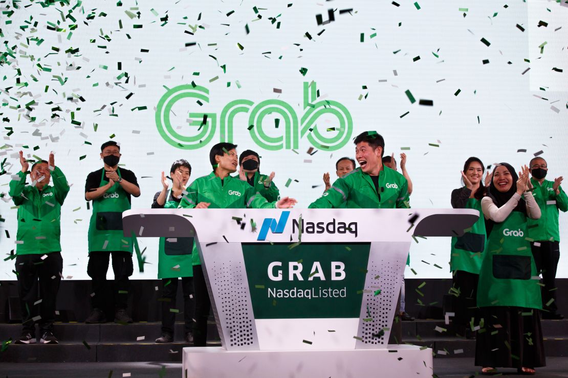 Grab's CEO, Anthony Tan, and co-founder Tan Hooi Ling, ring the bell as the Singapore-based company begins trading on the Nasdaq via a SPAC listing.