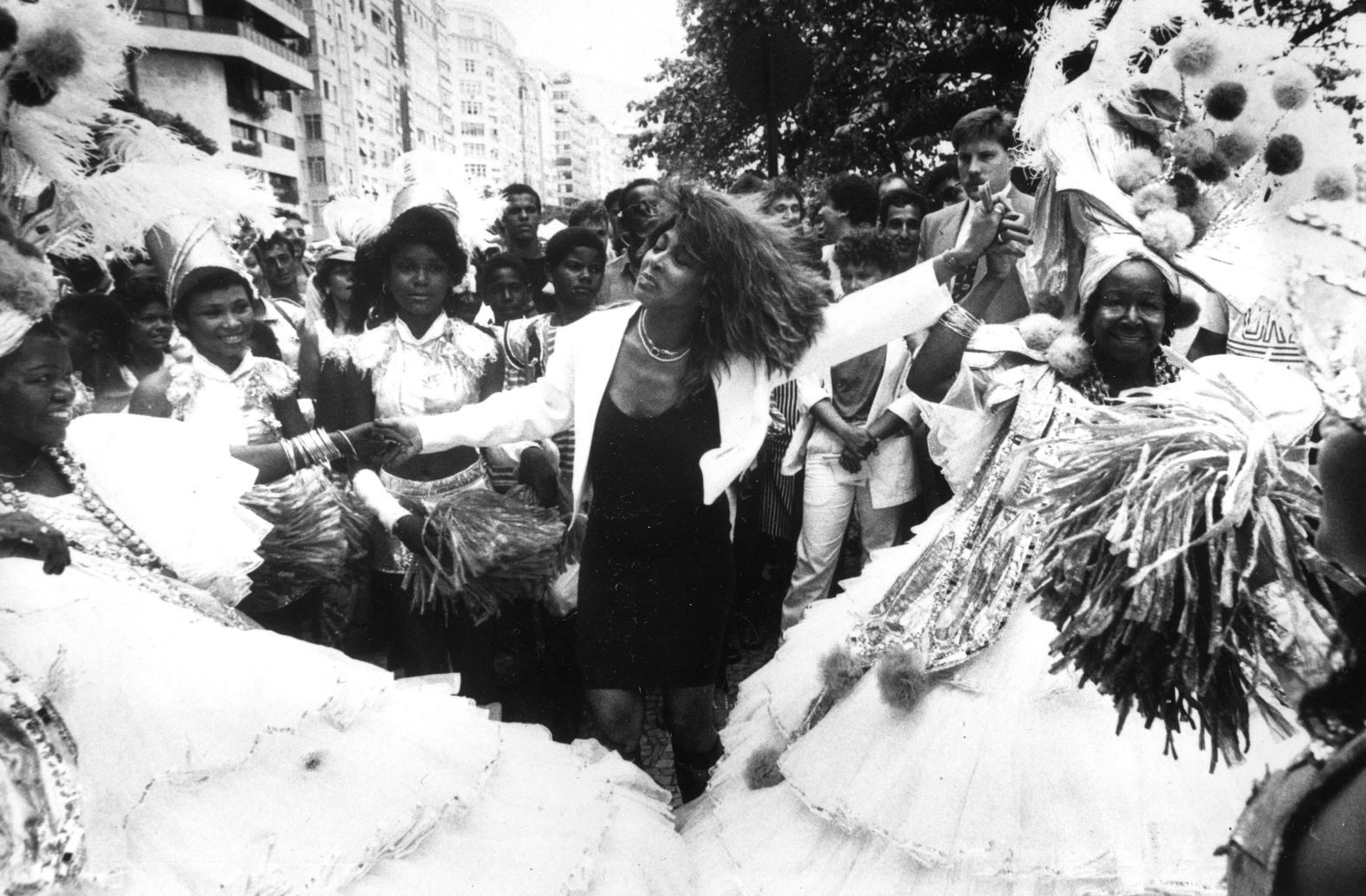 Turner dances on the streets of Rio de Janeiro with traditional Carnival performers in 1987. She was in Brazil as part of her world tour.