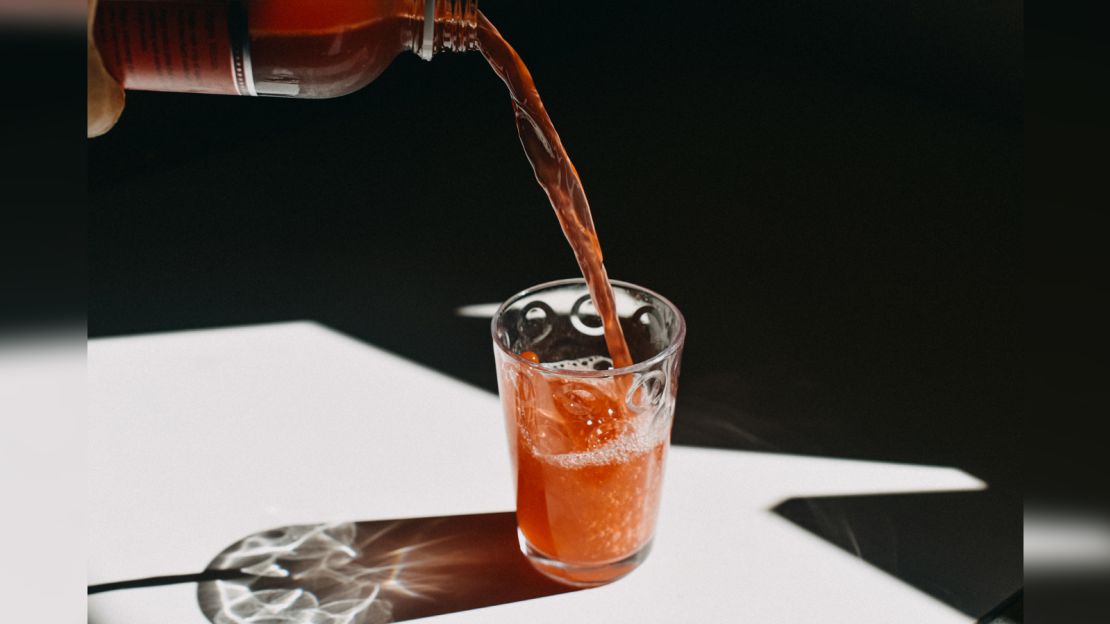 Kombucha Pouring in a Drinking Glass