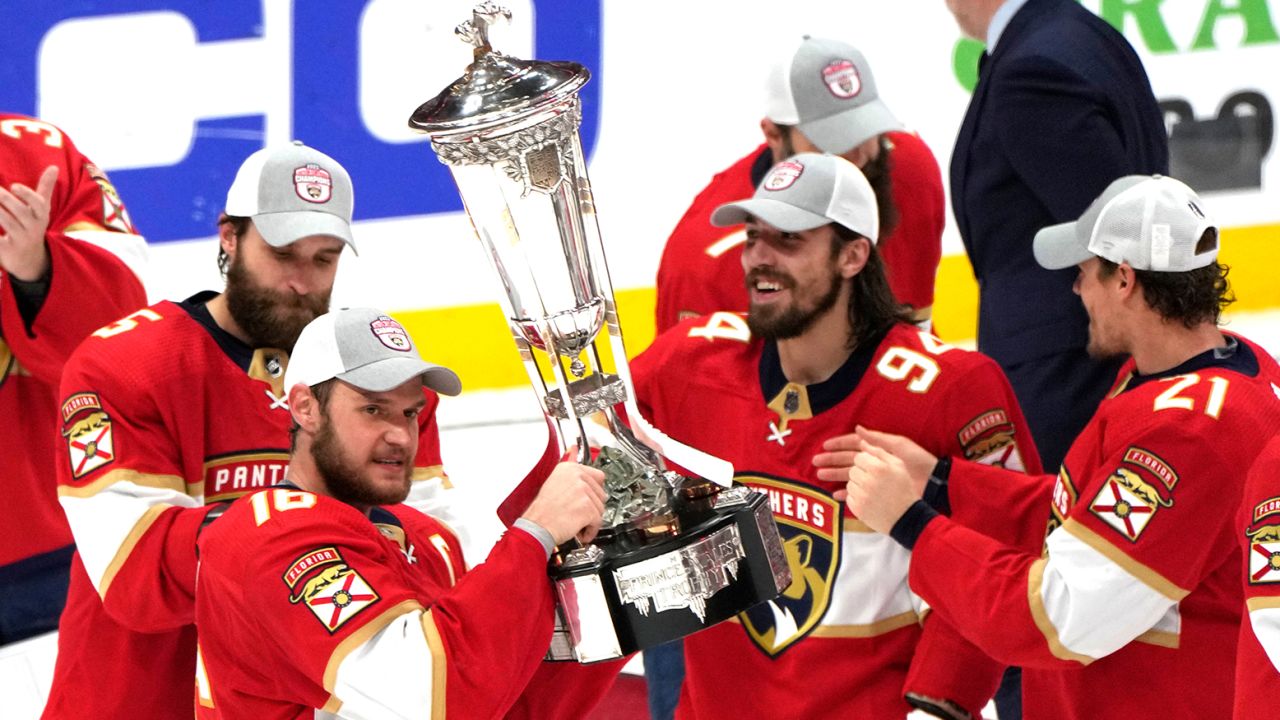 Florida Panthers center Aleksander Barkov holds the Prince of Wales trophy after the Panthers won Game 4 of the NHL hockey Stanley Cup Eastern Conference finals against the Carolina Hurricanes in Sunrise, Florida.