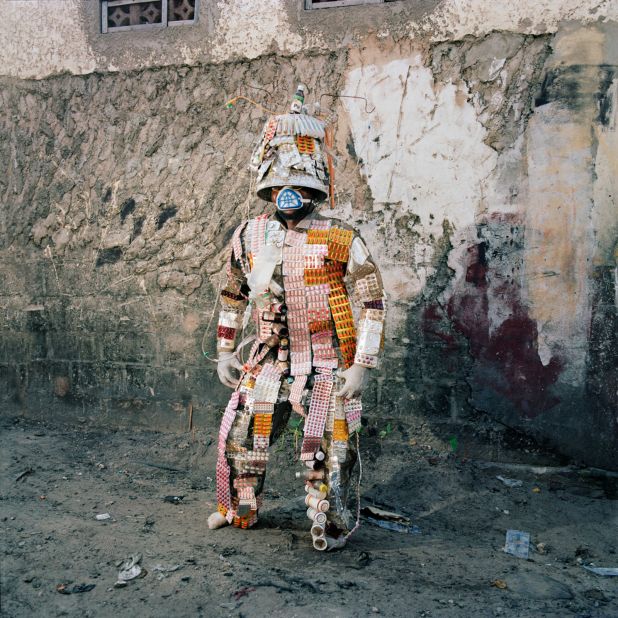 In this photo, Florian Sinanduku poses in his costume made from pill packets, in Selembao district, Kinshasa. The costume addresses healthcare issues such as counterfeit medicine in the DRC. "Finding medicine is still a big issue. You never know where it comes from and what it is made of," Sinanduku said.